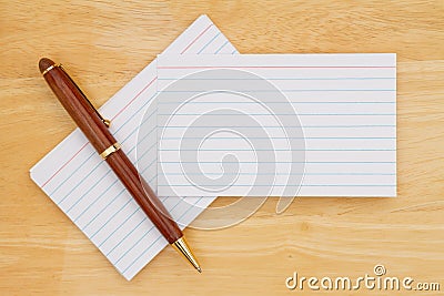 Retro white paper index cards with pen on wood desk Stock Photo