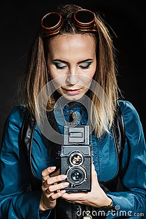 Retro woman with old camera. Steampunk. Stock Photo