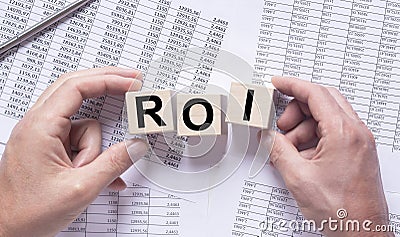 Return on Investment, ROI concept. acronym on wooden cube blocks Stock Photo