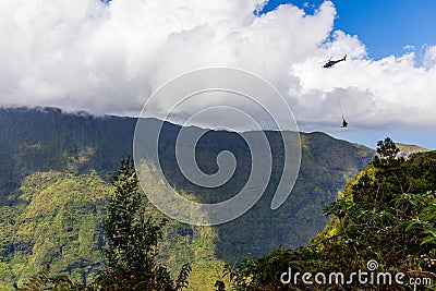 La Reunion Island - Helicopter winching goods to Mafate cirque Stock Photo