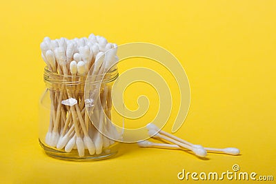 Reusable bamboo cotton buds on the yellow background Stock Photo