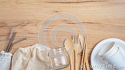 Reusable cutlery travel set. Eco-friendly bamboo silverware, stainless steel metal drink straws, mesh shopping bag, glass jar, Stock Photo