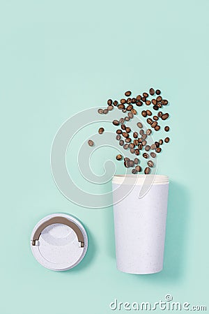 Reusable eco coffee cup with roasted coffee beans Stock Photo