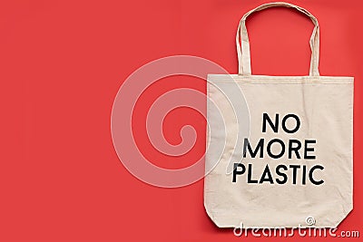 Reusable shopping bag no more plastic on red background. Cotton shopper on gray background,place for textTop view Stock Photo