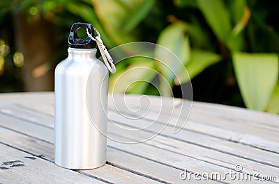 Reusable water bottle on a wooden table Stock Photo