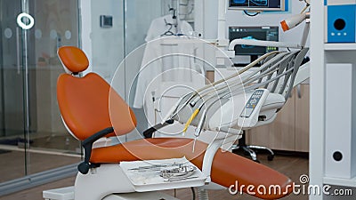 Revealing shot of orthodontist dentistry chair with nobody in, prepared for teeth dental health. Stock Photo