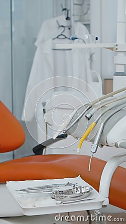 Revealing shot of orthodontist dentistry chair with nobody in, prepared for teeth dental health. Stock Photo