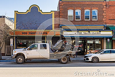 REVELSTOKE, CANADA - MARCH 16, 2021: street view in small town with historic buildings and modern cars early spring Editorial Stock Photo