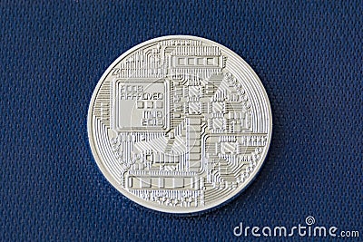 Revers side of bitcoin metal coin on blue fiber background Stock Photo