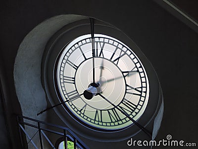 Revers side on the clock in old bell tower at ancient palace. Indoor view on the clock mechanism in tower. Stock Photo