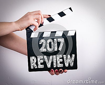 2017 review. Female hands holding movie clapper Stock Photo