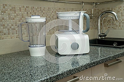 Disassembled multifunctional food processor on kitchen countertops. Smoothie Maker. Electric Kitchen and Household Stock Photo