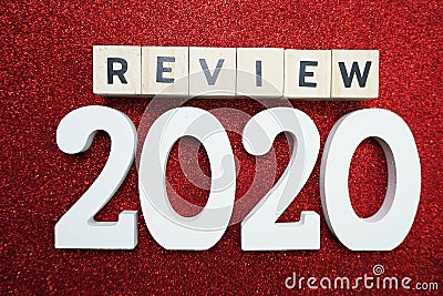 Review 2020 word alphabet letters on red glitter background Stock Photo