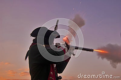 Revolutionary War Reenactor Firing Musket Stock Photo
