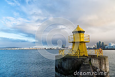 Reykjavik lighthouse tower on stone pier in iceland. lighthouse in sea. architecture in seascape and skyline Stock Photo