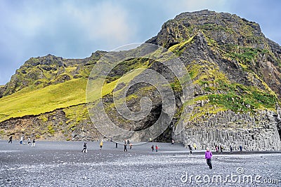 Reynisfjara Black Sand Beach Vik comes with scenic basalt columns and cliffs and is popular tourist destination in Editorial Stock Photo