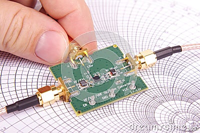 RF engineer inspect microwave mixer PCB Stock Photo