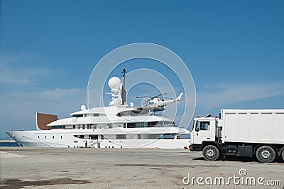 Rhodes, Greece. May 30, 2018. Akti Sachtouri, sea promenade in old port. Luxury yacht mooring while receiving supplies. Island of Editorial Stock Photo