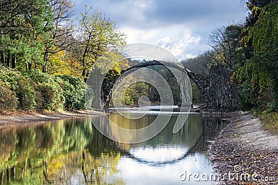 Rhododendron Park Kromlau, Germany, Europe. Incredible autumn view of Rakotz Bridge Rakotzbrucke, Devil`s Bridge Stock Photo