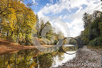 Rhododendron Park Kromlau, Germany, Europe. Incredible autumn view of Rakotz Bridge Rakotzbrucke, Devil`s Bridge Stock Photo