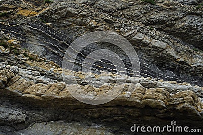 Rhythmic stratification of sedimentary rocks eroded by wave action Stock Photo