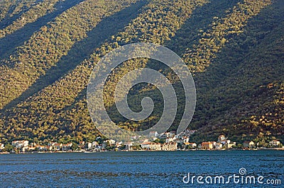 Rhythmic texture of a steep mountain slope, illuminated by the sun. Montenegro, Bay of Kotor Stock Photo