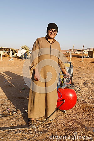 Riad, Saudi Arabia, February 15 2020: A young Saudi stands with his compressor on the side of the road Editorial Stock Photo