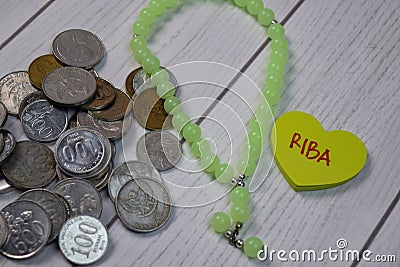 Riba text on sticky notes and coins isolated on office desk. It means increase. Islamic banking concept Stock Photo