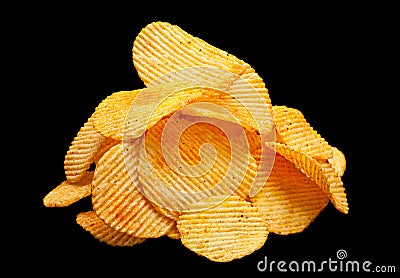 Ribbed potatoes chips on black Stock Photo