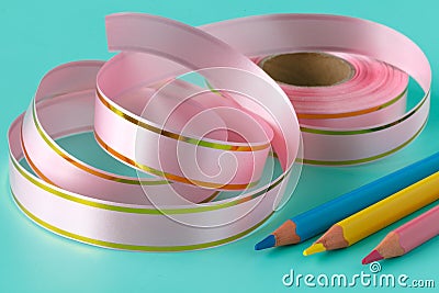 Ribbon tape and pen on aquamarine background Stock Photo