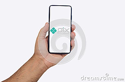 RibeirÃ£o Preto, SÃ£o Paulo, Brazil, 10-27-2020- hand holding smartphone, showing the pix application logo bank transfer applicati Editorial Stock Photo