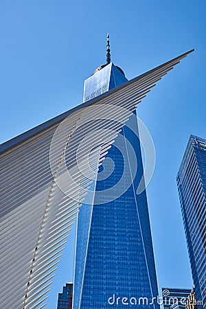 The ribs of the WTC Transportation Hub 2016 pass dramatically in front of One World Trade Center or Freedom Tower 2014 in Editorial Stock Photo