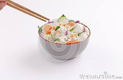 Rice bowl hand eating with chopstick, vegetables on white background Stock Photo