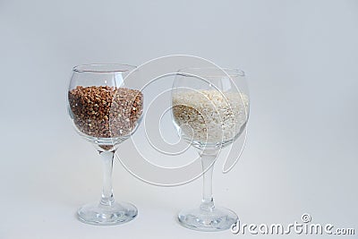 Rice and buckwheat groats stand in a wine glass on a white background Stock Photo