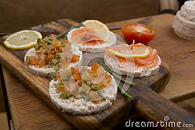 Rice cookies with vegetables and salmon. Vegetarian snacks. Stock Photo
