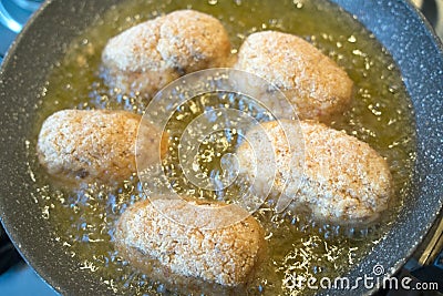 Rice croquettes frying in boiling oil Stock Photo