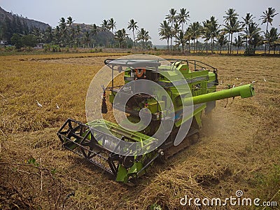 Rice harvesting machine, paddy cutter In the fields, Kanyakumari, Tamil Nadu Editorial Stock Photo