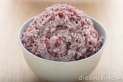 Rice mix purple rice berry rice in white cup. Stock Photo