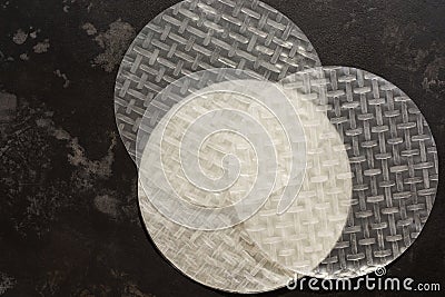 Rice paper for spring rolls on a dark stone background. View from above. Stock Photo