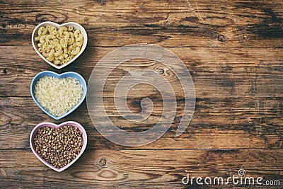 Rice, pasta, buckwheat, in bowl heart shape Stock Photo