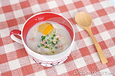 Rice porridge with egg in cute bowl Stock Photo