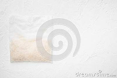 Rice in portion bags, on white stone table background, top view flat lay, with copy space for text Stock Photo