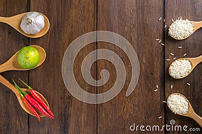 Rice, Red chilli, garlic and lemon on wooden background Stock Photo