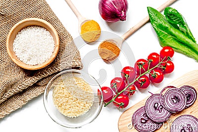 Rice, spices and vegetables for paella on white desk background top view Stock Photo