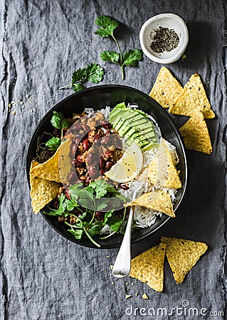 Rice with spicy beans beef minced with corn chips on a gray background, top view. Mexican style food Stock Photo