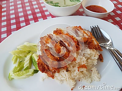 Rice steamed with Fried chicken on pink white grid background table (Hainanese Roasted chicken rice) Stock Photo