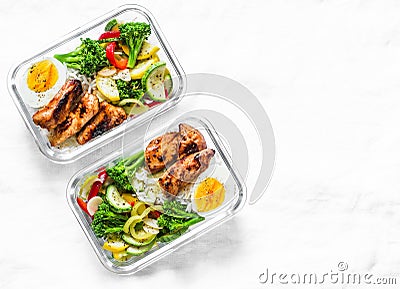 Rice, stewed vegetables, egg, teriyaki chicken - healthy balanced lunch box on a light background, top view. Home food for office Stock Photo