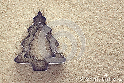 Rice texture with symbol Christmas tree mold with copy space. Stock Photo