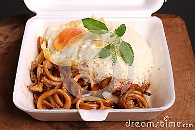 Rice topped with spicy fried squid, Stock Photo