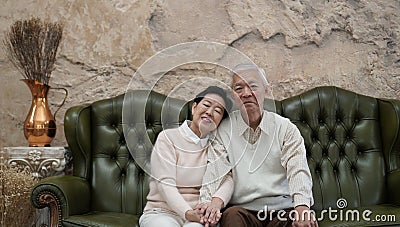 Rich Asian senior parents sit in luxury beautiful house background Stock Photo